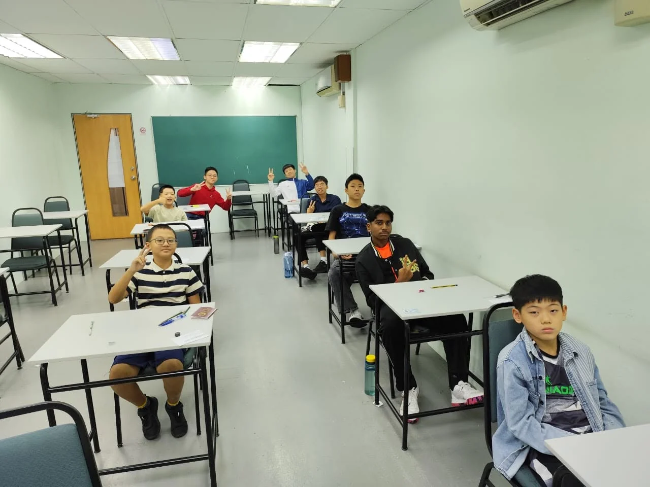 student at an exam desk, focused, headphones for listening